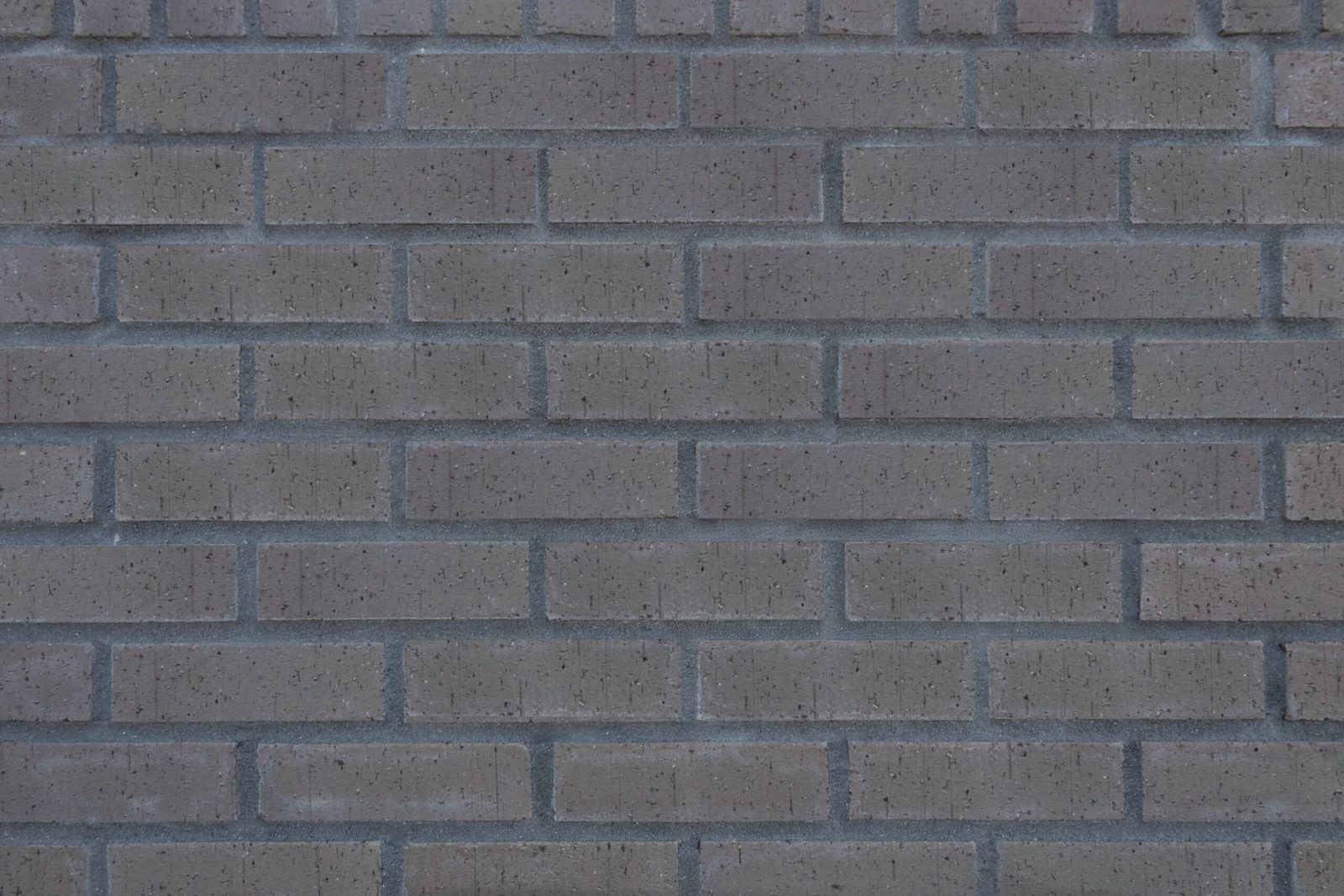Gray brick wall with dark mortar