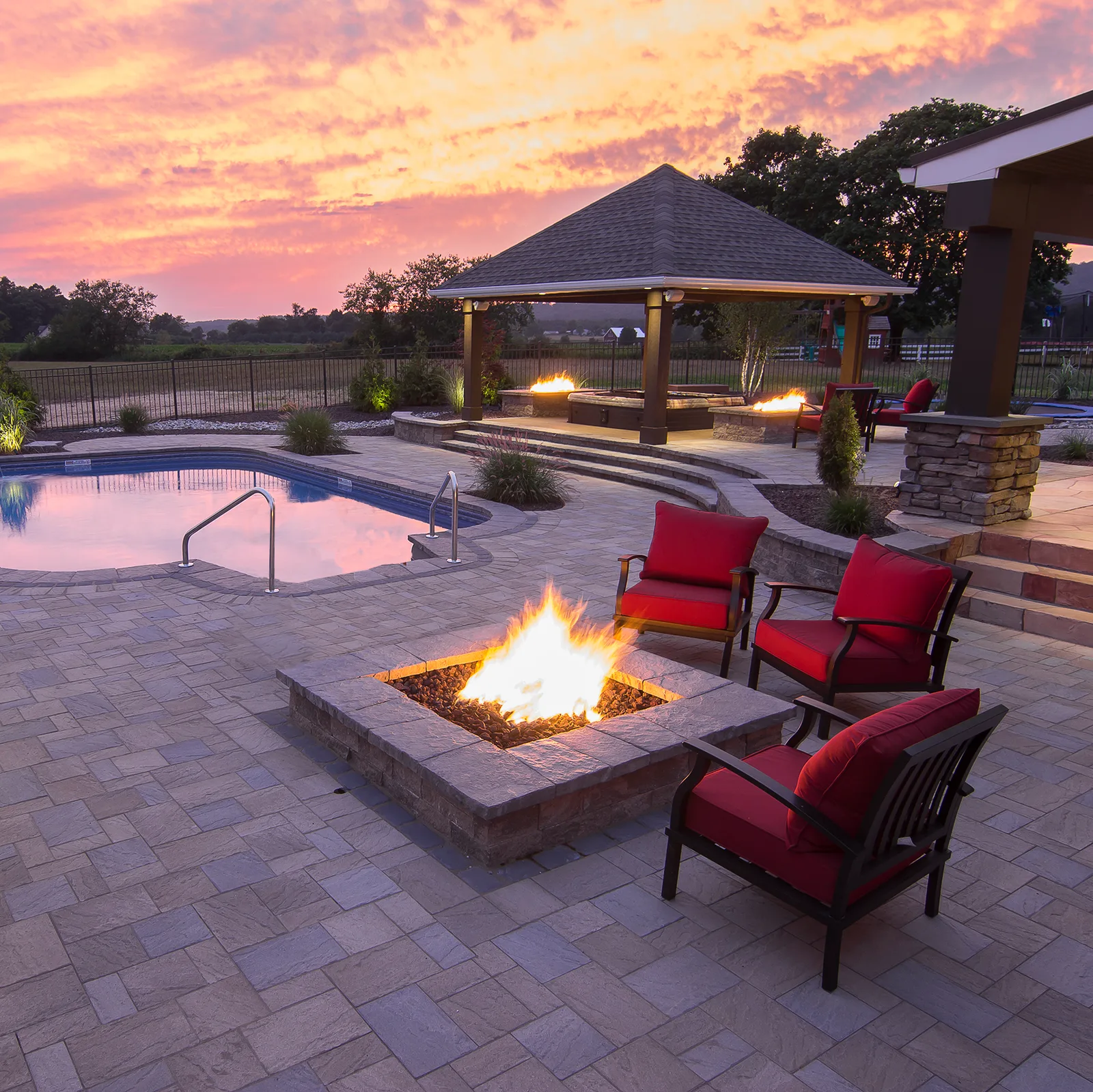 Patio fire pit burning at sunset
