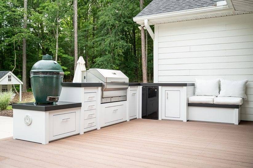 White outdoor kitchen with built-in grill and smoker